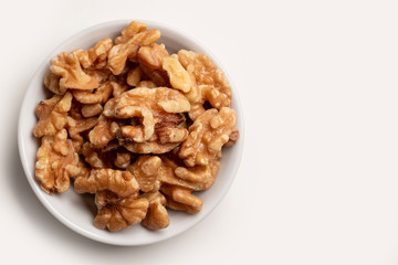 walnuts in a bowl isolated on white close up 