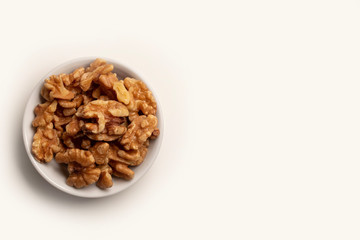walnuts in a bowl isolated on white background with copy space 