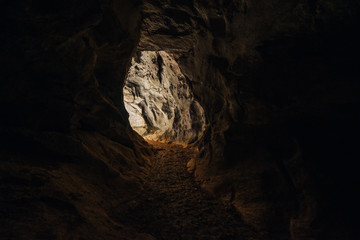 View out of a cave. Dark photo of an entrance or exit from a cave.