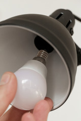 Replacing light bulb at home. Simple DIY housework maintaince.