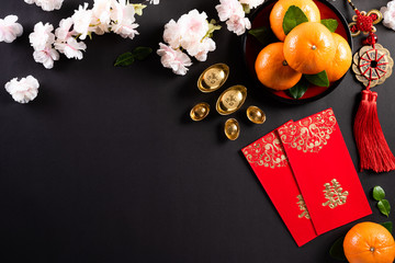 Chinese new year festival decorations pow or red packet, orange and gold ingots or golden lump on a...