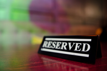 Plastic reserved plate on an arranged restaurant table