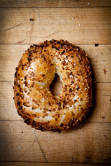 Onion bagel on wood cutting board