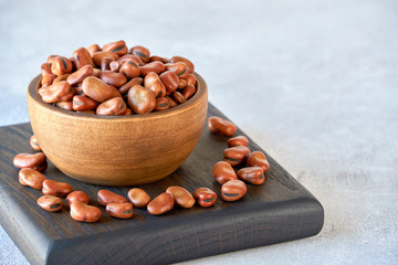 Dried fava bean in wooden bowl. Close up  