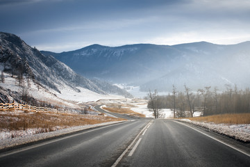 Winter road on mountains. Sunny weather.