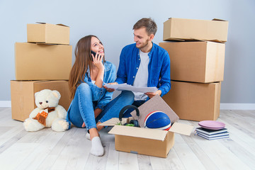 Caucasian pleasant young couple in love looking at the visualisation of their home interior design.