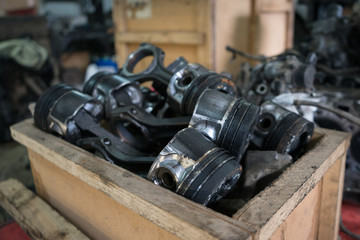 Old engine pistons. Junkyard garage.