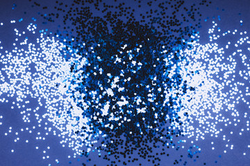 Blue sparkles on monochrome background. Top view