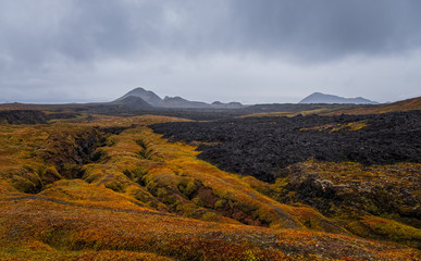 Leirhnjukur old black lava field and smoke in Iceland, overcast. Cloudy day in September 2019