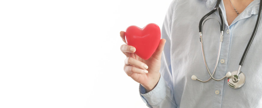 Medical worker holding a red heart as a symbol of health, health care  concept