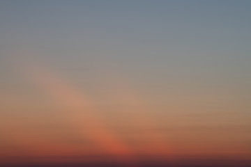 A beautiful sunset sky above a light cloud. Bright orange sky.