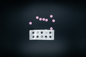 Pills on dark background close up