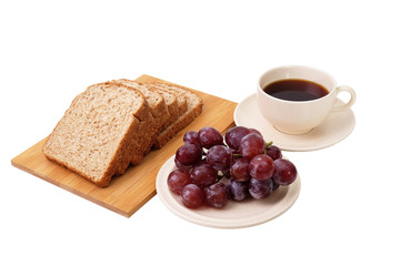 Whole grain bread and grapes serve with a cup of coffee isolated on white background..