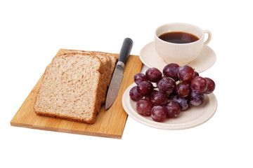 Whole grain bread and grapes serve with a cup of coffee isolated on white background..