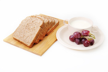Whole grain bread and grapes serve with milk..