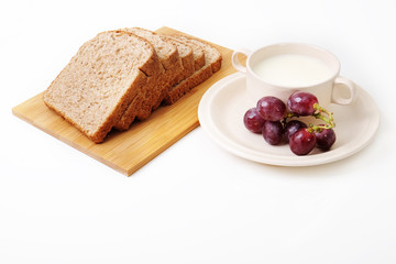Whole grain bread and grapes serve with milk..