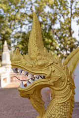 Gilded head of a dragon sculpture at the temple of Wat Mixai in  Vientiane, Laos.