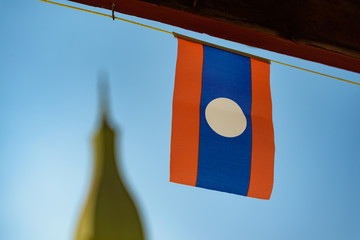 A Laos flag at the Wat Phra That Luang, Vientiane, Laos.