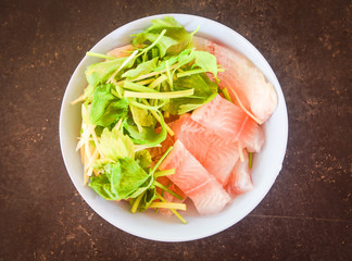 Fresh fish fillet sliced with celery - Raw tilapia fillet fish on white bowl and ingredients for cooking food
