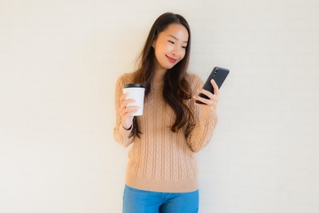Fototapeta premium Portrait beautiful young asian women smile happy use mobile smart phone