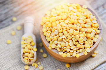 Soybean in a wooden bowl agricultural products on the sack background - Peeled Split Soybean or Soya Bean without husk