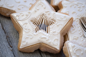 Christmas cut out cookies decorated in royal icing on wooden table