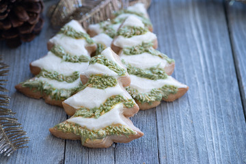 Christmas; tree cut out cookies decorated in royal icing on wooden table