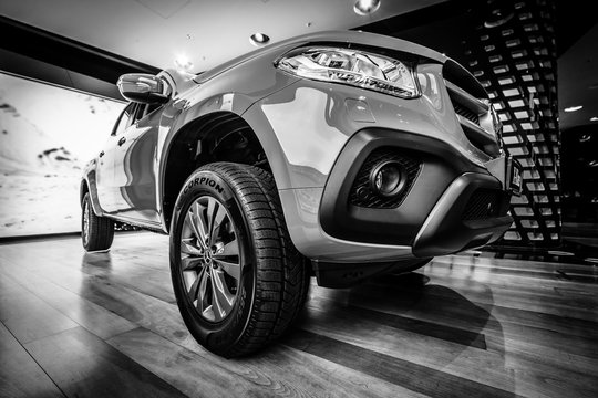 BERLIN - DECEMBER 21, 2017: Showroom. Mid-size luxury pickup truck Mercedes-Benz X-Class X220d 4Matic. Black and white. Since 2017.