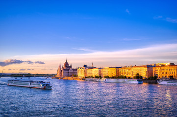 Fototapeta premium The Hungarian Parliament Building located on the Danube River in Budapest Hungary at sunset.