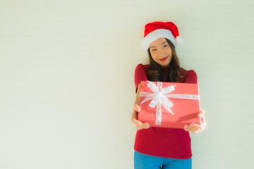 Portrait beautiful young asian women wear santa hat in christmas festival with gift box