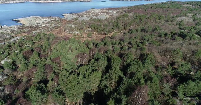 Drone flies over rocky island in Norway. Arial footage of Flekkerøya.