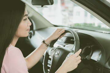 Fototapeta na wymiar Asian girl smiling relaxing sitting and prepare drive safety