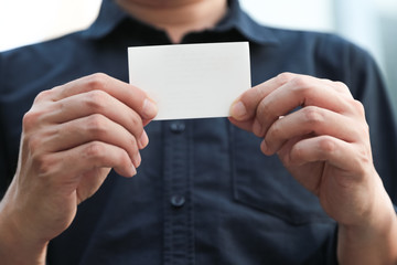 Fototapeta premium Confident male business executive with empty white business card