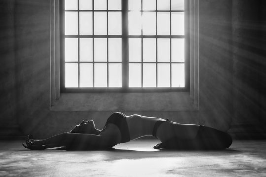 black and white portrait of beautiful and sexy asian woman in lingerie posing and lying on floor