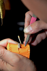 Fototapeta premium Close up Goldsmith cuting rubber mold in jewelry process unfinished