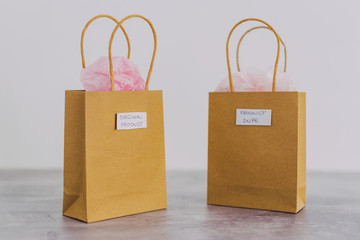 original product vs dupe imitation, shopping bags with labels side by side with similar paper color