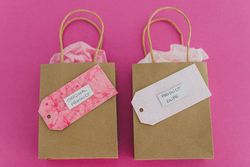 original product vs dupe imitation, shopping bags with simila price tags side by side symbol of cheap product alternatives