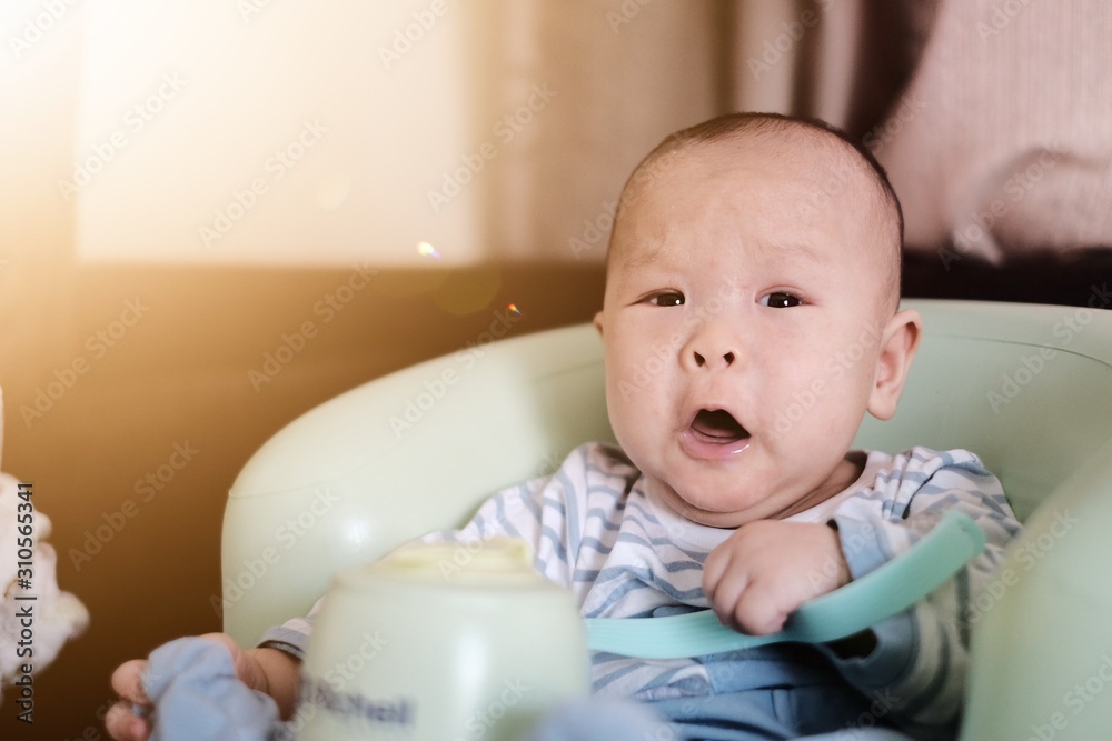 Wall mural baby with bottle of milk.