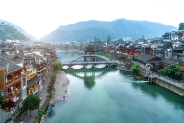 Fototapeta premium Folk houses along the river in the ancient city of Phoenix, Hunan