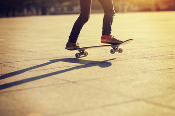 Skateboarder skateboarding at sunset city