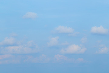 Floating clouds, fluffy colors against the blue sky