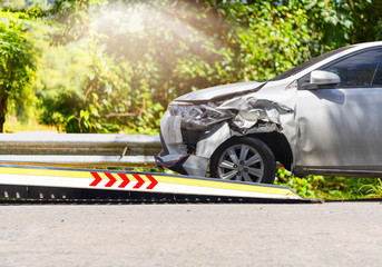 accident Car Slide on  truck for move. White car have damage by accident on road take with slide...