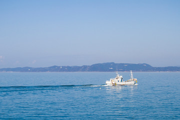 fishingboat sail in blue sea