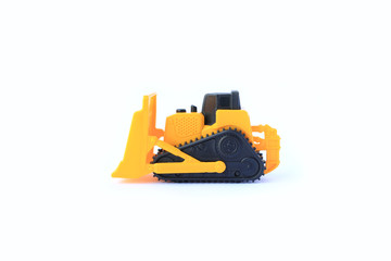 Obraz premium The yellow toy car Bulldozer isolated on white background. Children's tractor toy. Wheel loader construction car model.