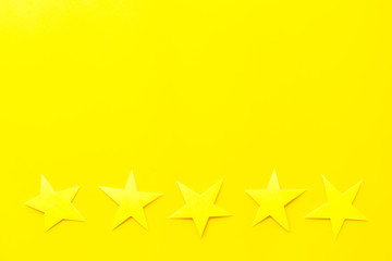 Customer experience concept. Estimate service quality. Five stars on yellow background top-down copy space