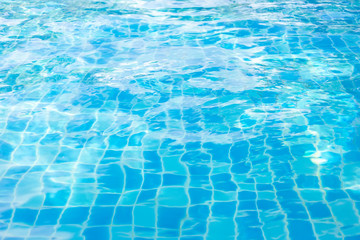The water is dropping into the pool. Wave on the surface caused by the drop of water. The waves on the surface caused by the drops of water in the pool.