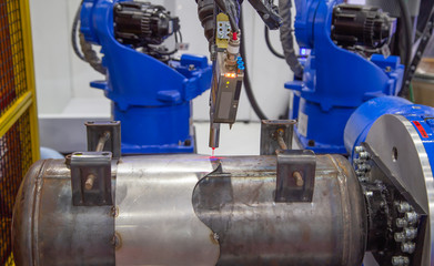 Seam tracking laser system for automated robot welding arm.
