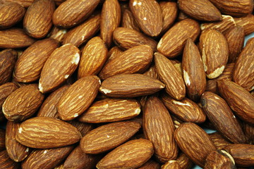 Top view brown Almond nuts close up background