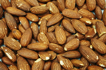 Top view brown Almond nuts close up background