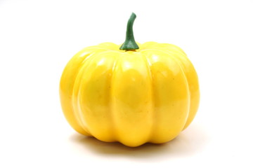 Yellow artificial pumpkin isolated on white background